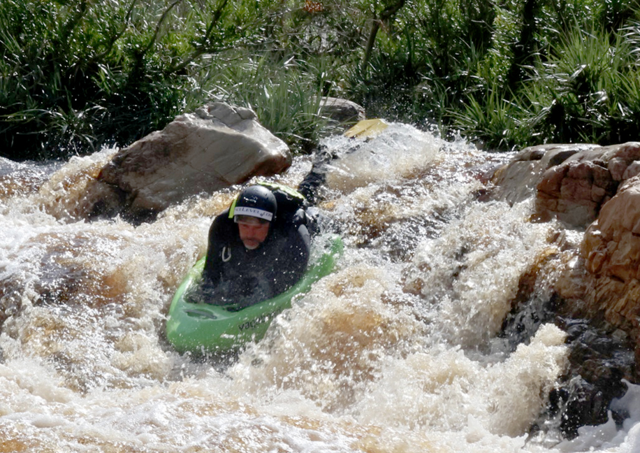 Charl van Rensburg dropping a waterfall on the green LEKKER Tana riverboard