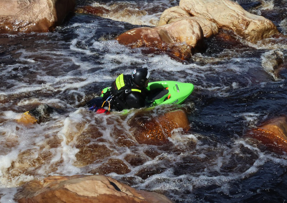 Charl van Rensburg charging dark whitewater on the Tana