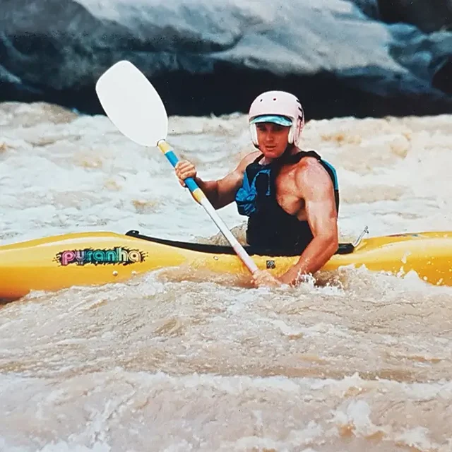 Celliers Kruger paddling a yellow kayak through whitewater