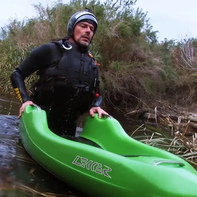 Charl van Rensburg on the riverbank with a green LEKKER kayak